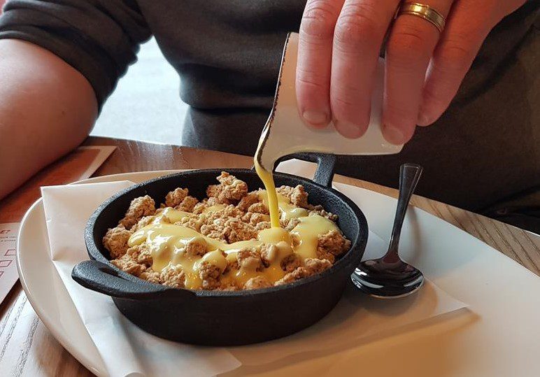 Apple crumble with custard dessert