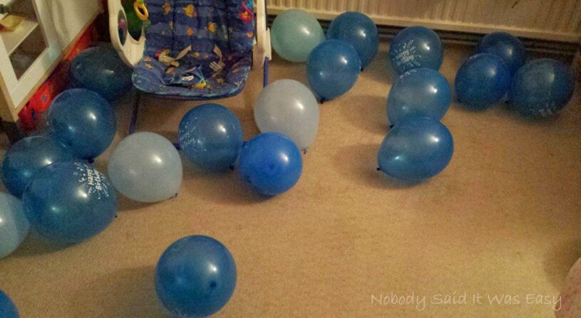 Many blue balloons on the floor ready for a birthday