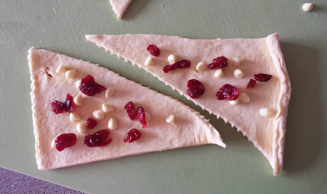 Jus-rol croissants before baking with toppings on (dried cranberries and white chocolate chips