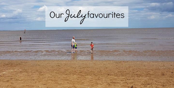 A photo of a beach with people in the far distance. The text on the photo says Our July Favourites