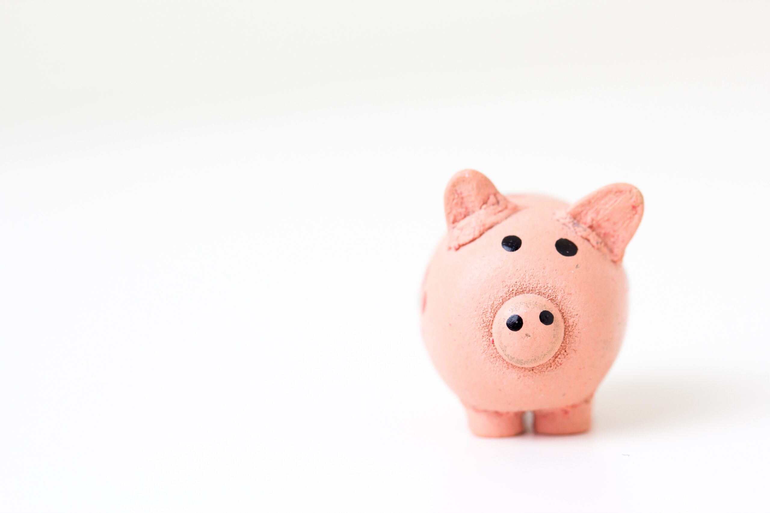 a pink pig money box set to the right of the image, an a blank white background; 9 tips on reducing waste and saving money