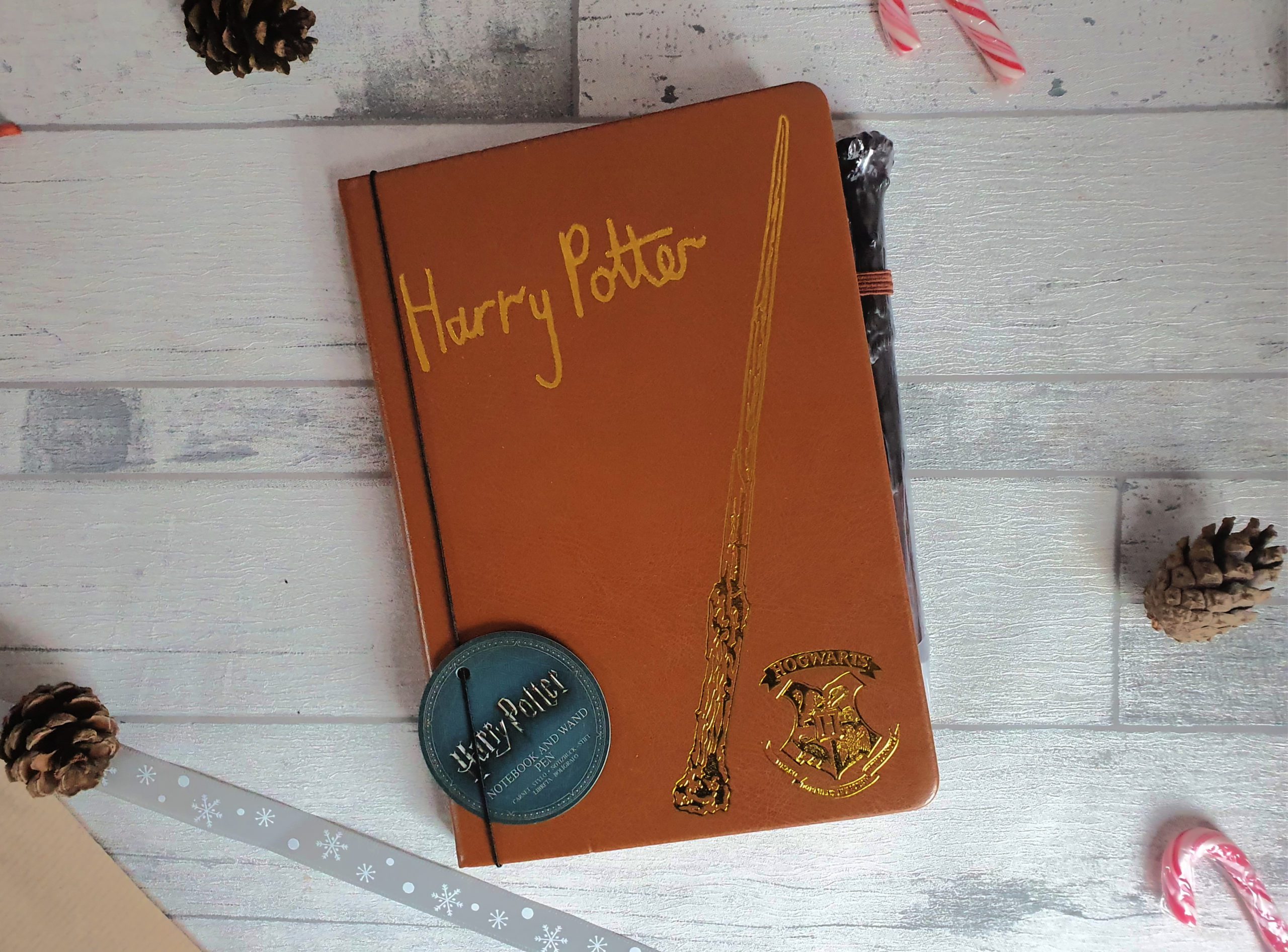 Notebook and wand pen, Harry Potter written on the front