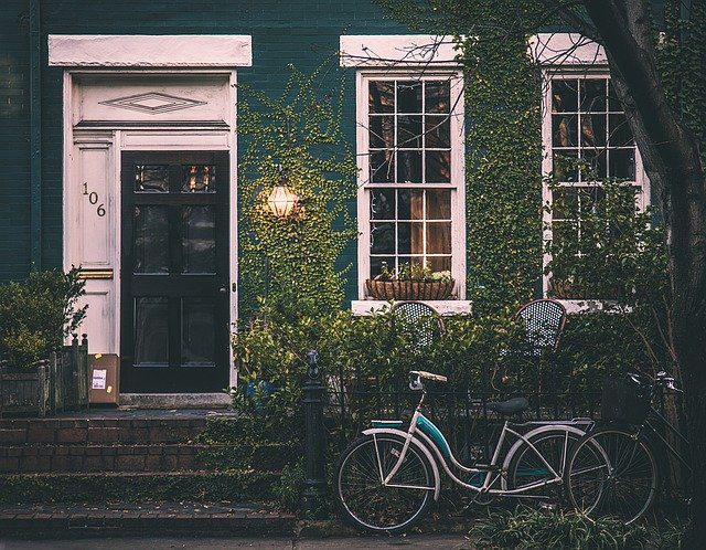house with ivy covering the walls and a bicycle in front, How To Add Value To Your Property When You Are Selling Up