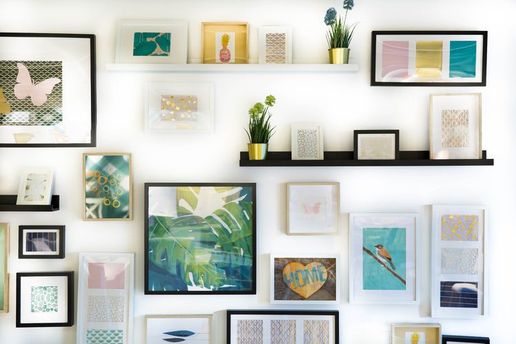 variety of framed images on a white wall