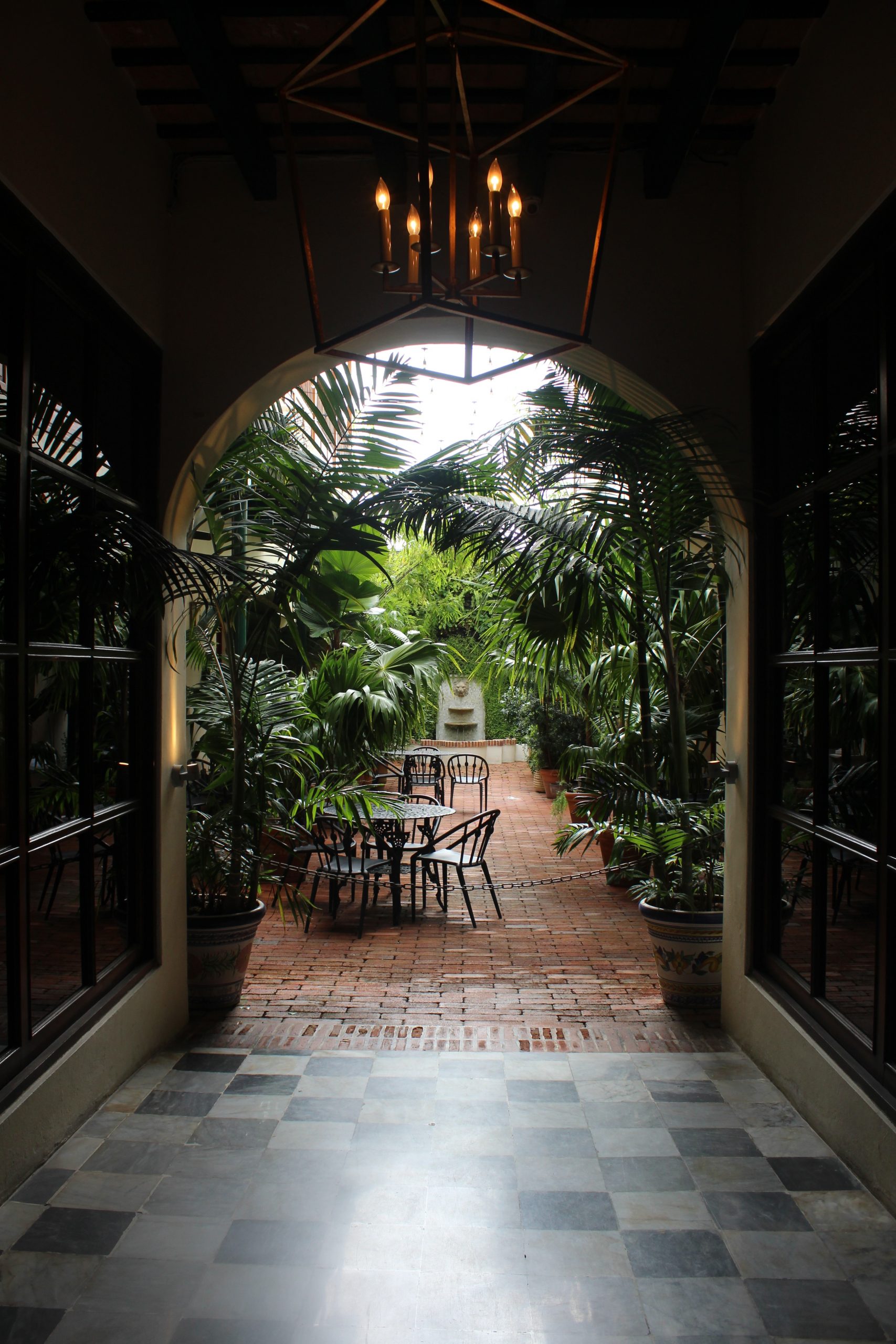 outdoor passage leading to patio table through an arch; The Anatomy Of The Perfect Indoor-Outdoor Space