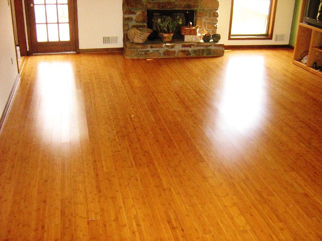 expanse of wood flooring with a brick fireplace at the end of the room; Five Kinds of Wood for Your Hardwood Floor