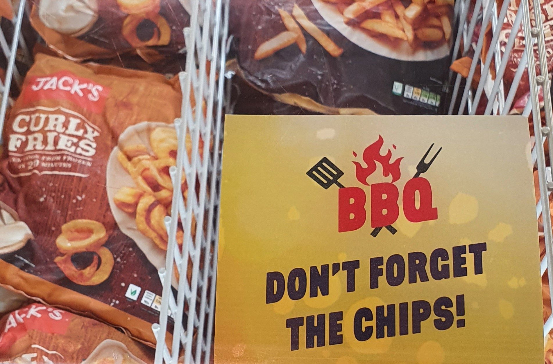 a sticker on a freezer in Jack's supermarket saying "don't forget the chips!"