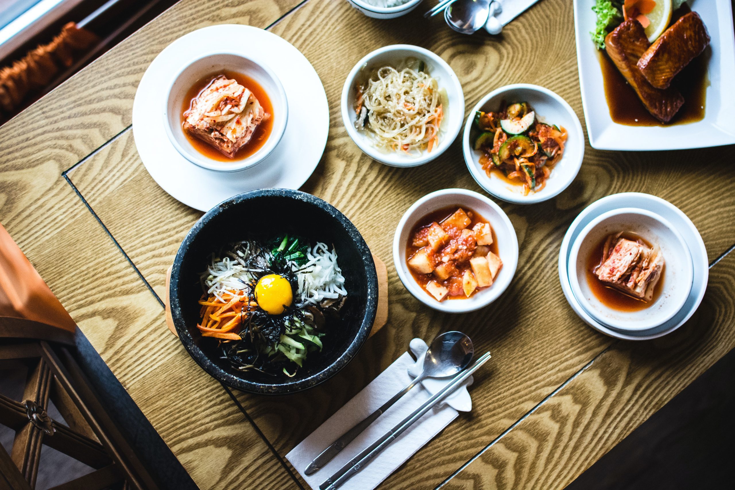 bowls of Japanese food on a wooden table; The Travels We Make Without Going Anywhere
