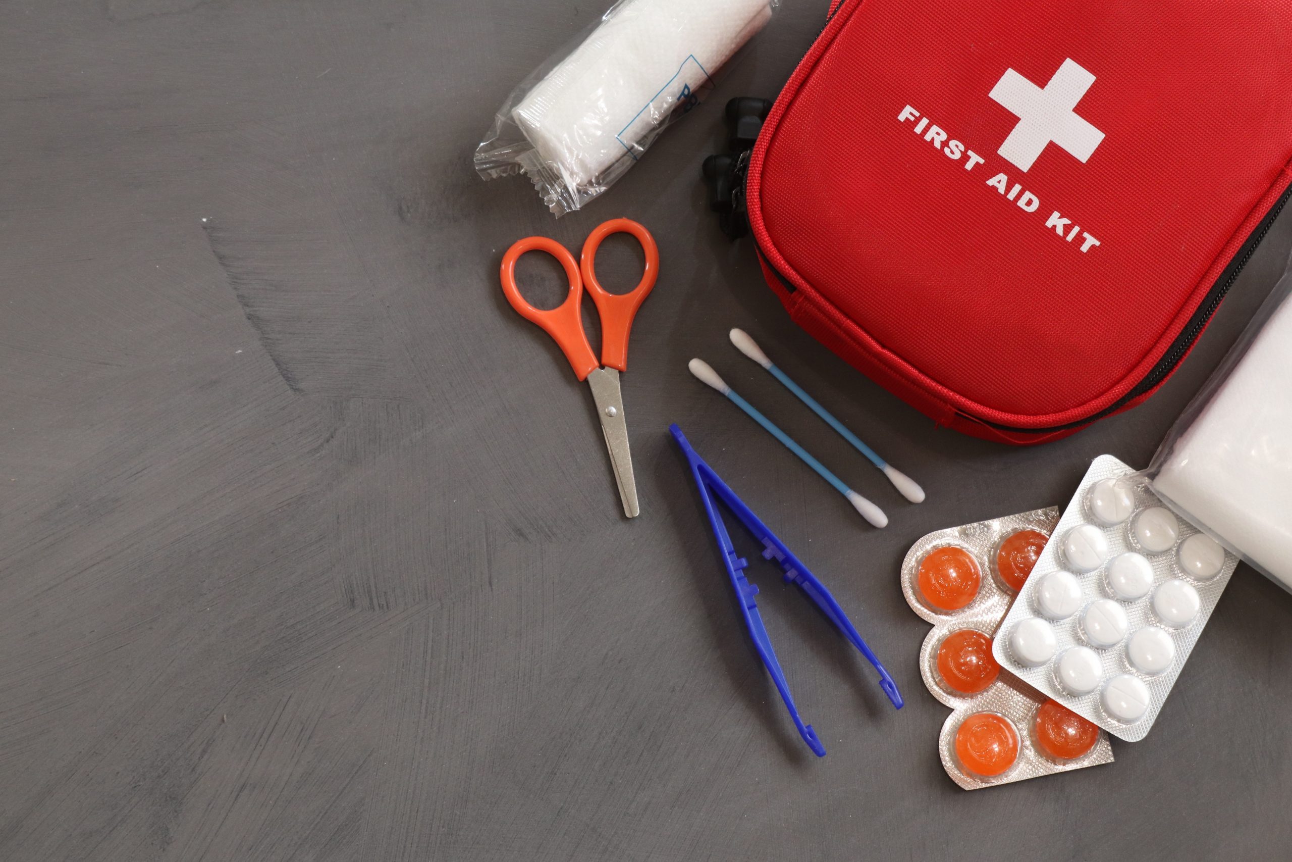 contents of a first aid kit including scissors, tweezers, cotton buds; 6 Things Every Family Home Should Have