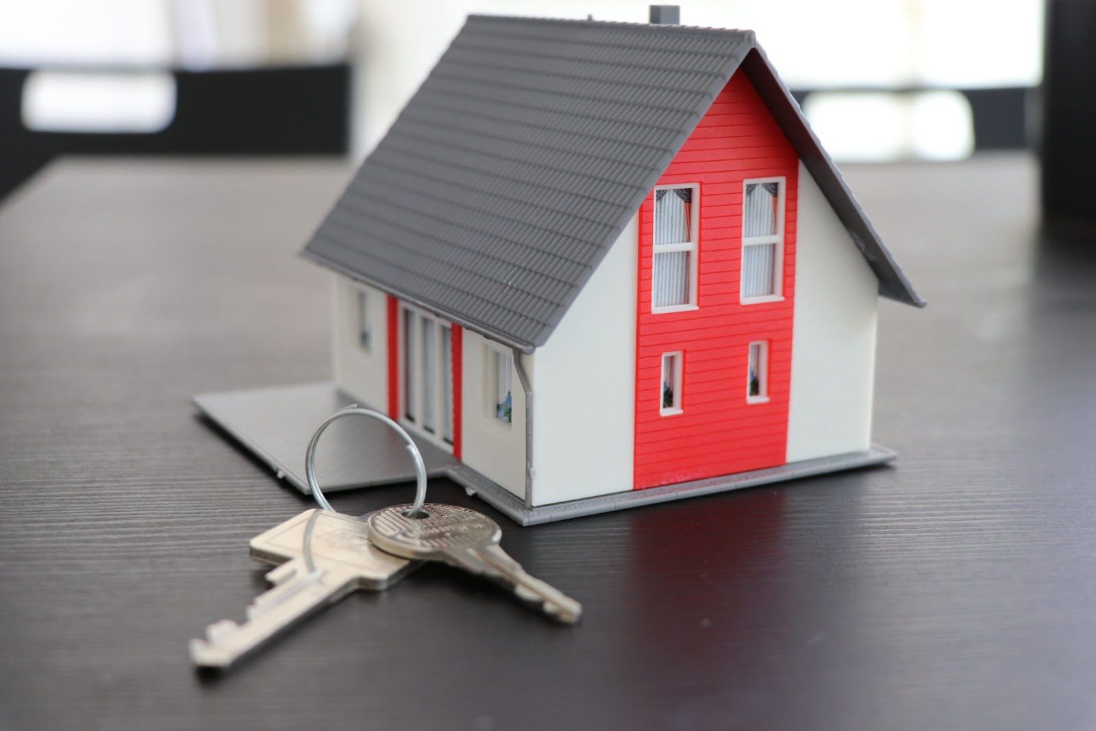 model of a house with a set of keys set by it; Amazing Home Changes That Will Make Your Property Better