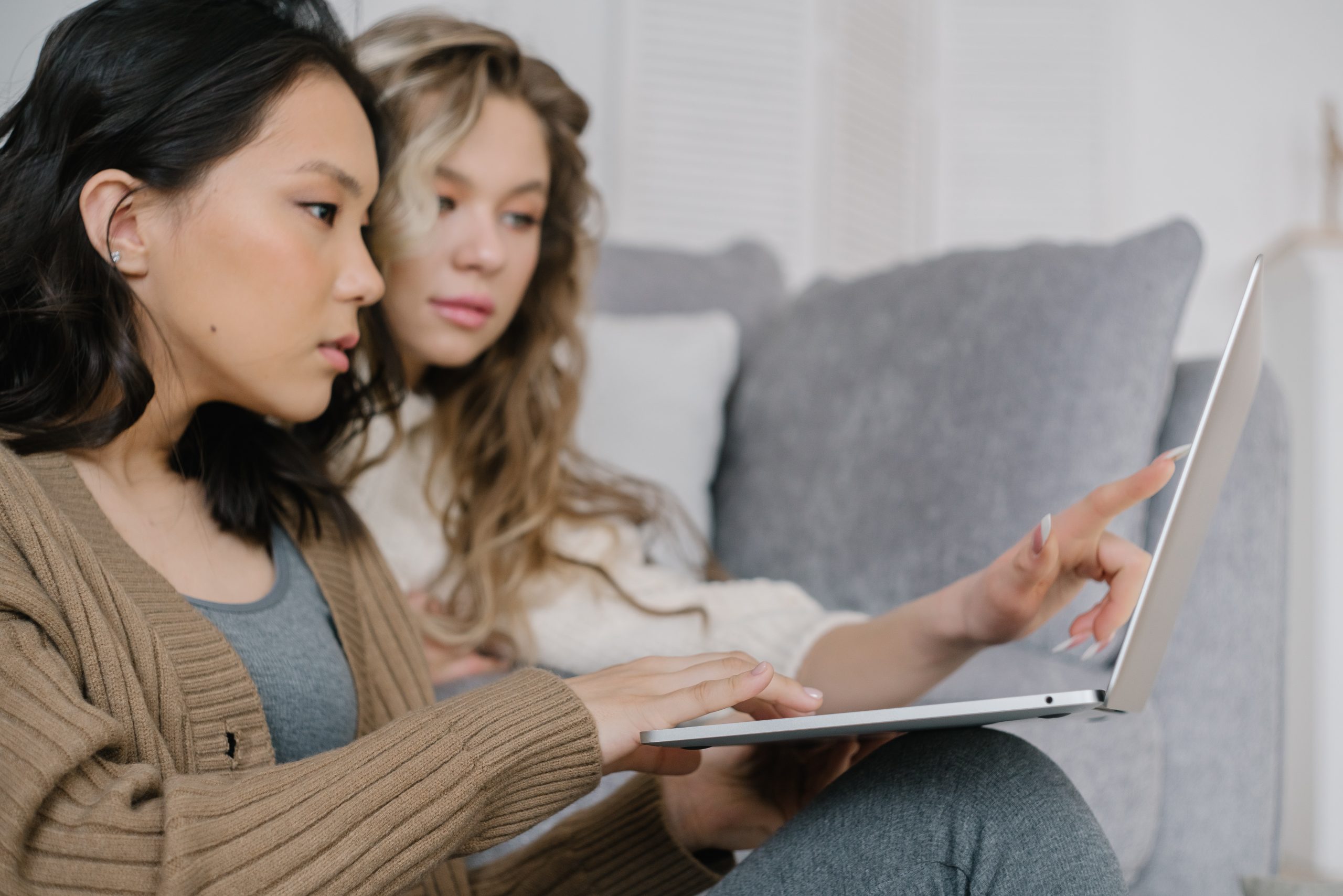 two women, one is blonde and one is brunette, sat looking at an iPad; How to Get a Fresh Start Ideas for New Life