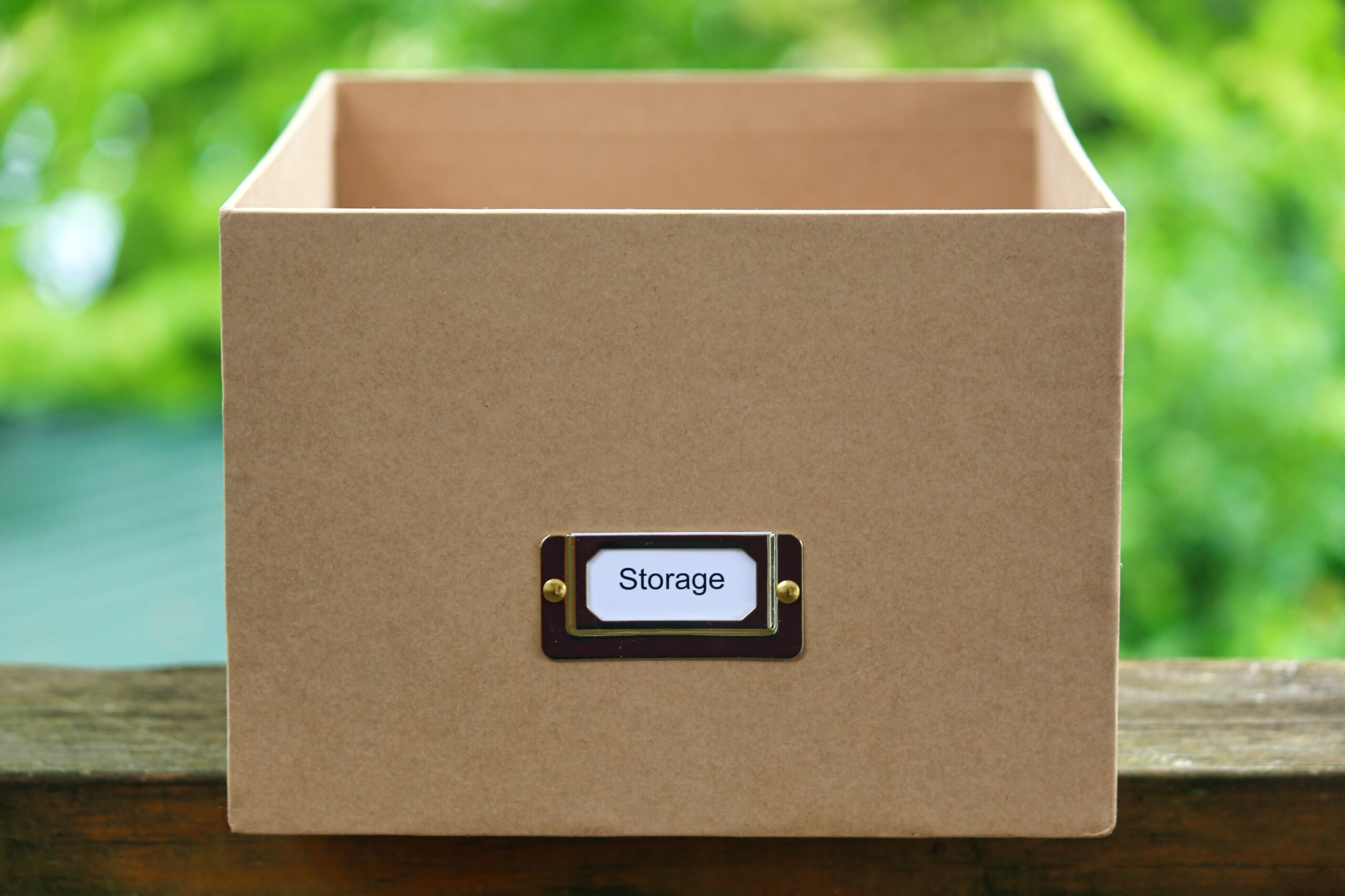 a brown square box with "storage" written on the front; 5 Tips On How To Down-Size When The Kids Leave Home