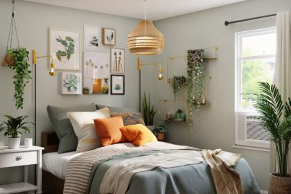 a large bed in a medium sized room with a grey duvet and orange pillows. There are plants in the room and o small window to the right of the bed; 16 Tips On What To Do When Revamping Bedrooms