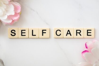 scrabble letters spelling out self care; Mental Health And Self-Care Tips For Busy Lives