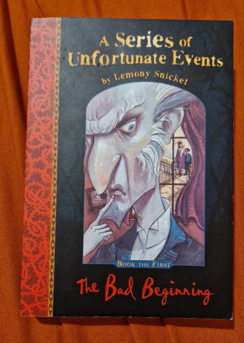 A paperback copy of A Series Of Unfortunate Events The Bad Beginning