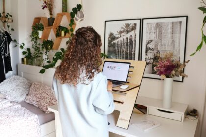 a woman standing at a desk using a laptop; 10 Things To Have In Place For Your Online Start-Up