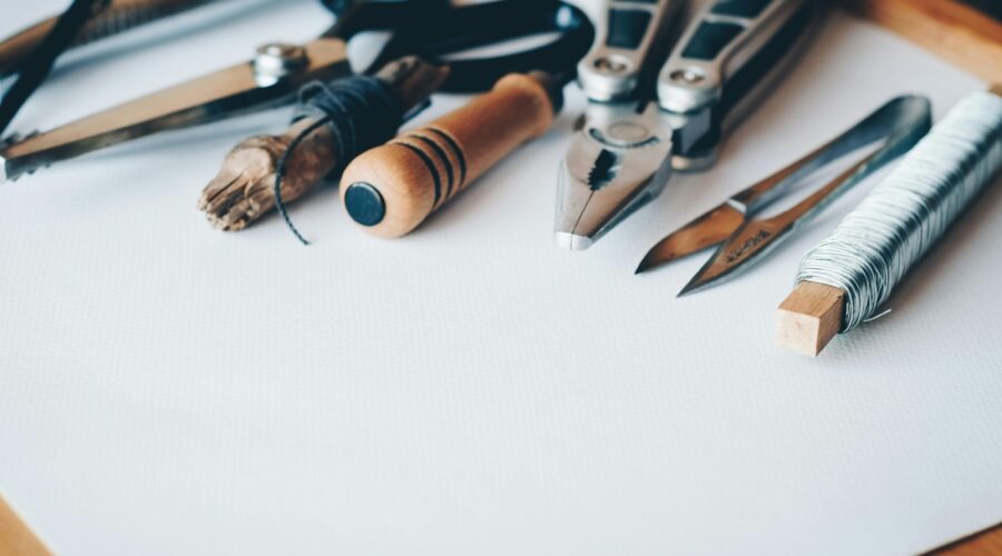 a selection of craft tools on a white surface; 14 Tools Every Serious Crafter Should Own