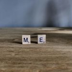two scrabble tiles on a wooden surface spelling out M E; An Honest Explanation Of Living With MECFS