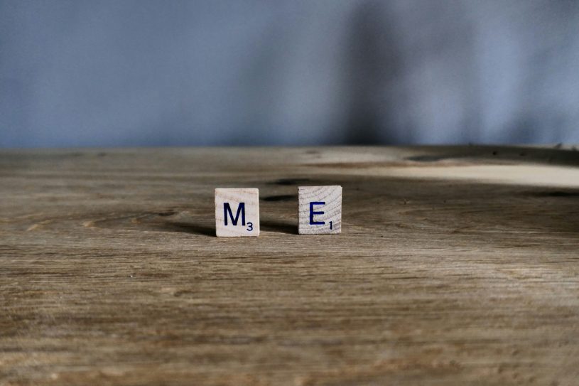 two scrabble tiles on a wooden surface spelling out M E; An Honest Explanation Of Living With MECFS